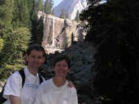 Perched atop a rock, the happy couple poses with Vernal Falls.