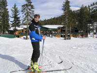 Carey poised near the base lodge, wearing his comfortable yellow boots.