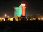 PC034145 Our moho with dish up in front of the Christmas-colored Hilton at night.