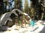 PC054280 Debbie finds one of several big rocks that formed part of shelters used by others in the party.  This was more difficult to find than you'd imagine, what with the snow covering the paths.
