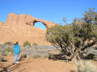 Debbie boggles at a high, sturdy-looking arch conveniently located near the road.