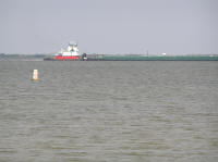 Every now and then a big barge goes down the channel, maybe a mile out.